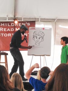 Author/illustrator Don Tate draws at an event.