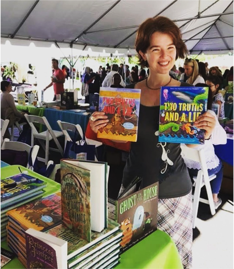 Ammi-Joan Paquette with her TWO TRUTHS AND A LIE books at a festival.